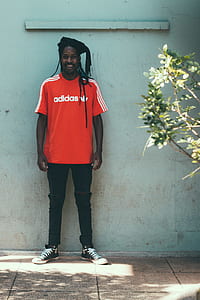 man standing beside wall thumbnail