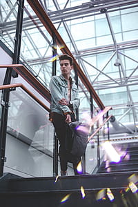 Man in Blue Jacket Standing on Stairs thumbnail