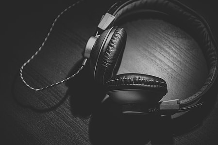 black corded headphones on brown wooden table thumbnail