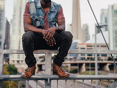 Man Sitting In City Photo thumbnail