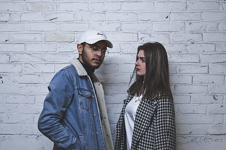 man and woman standing white painted wall thumbnail