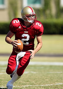 man in red football gear running while holding football thumbnail