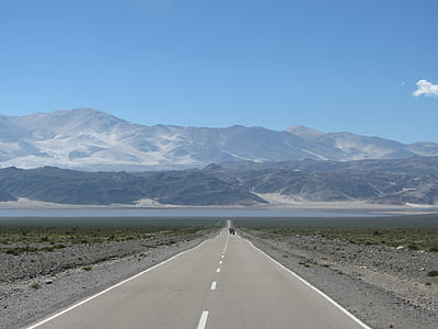 clear concrete road near mountains thumbnail