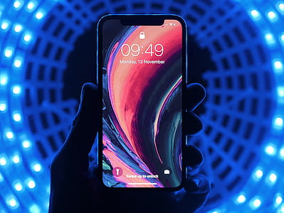 person holding space gray iPhone X thumbnail