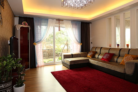 brown sectional couch beside red area rug thumbnail