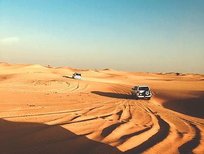 two white SUV's on sand dunes thumbnail
