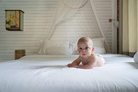 baby boy lying on bed thumbnail