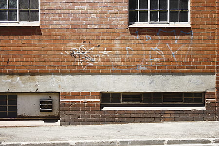 brown bricked building with graffiti thumbnail