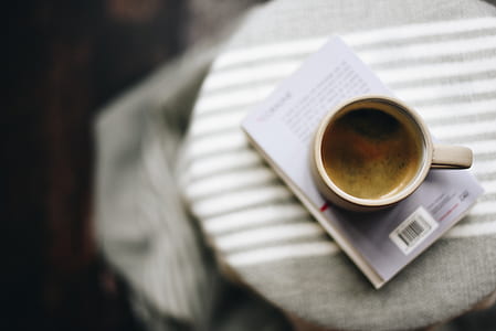 white ceramic mug on book thumbnail