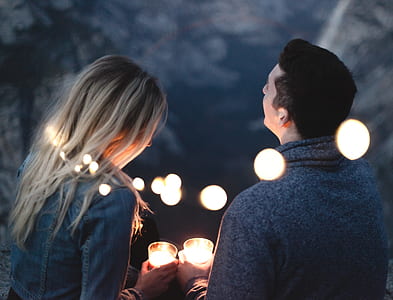 man and woman holds pillar candles thumbnail