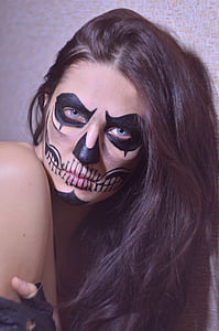 photo of woman putting skull makeup thumbnail