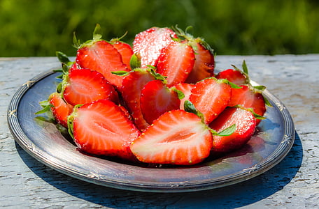 sliced strawberries on round gray plate thumbnail