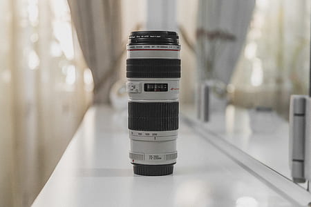 black and gray camera lens on white surface thumbnail