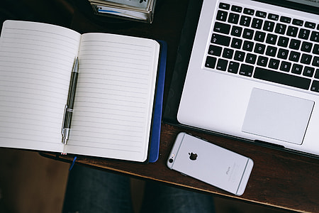 Elegant workspace with Macbook, iPhone, business cards and notebooks thumbnail