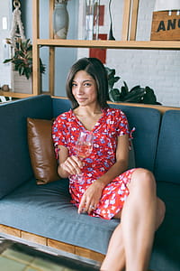 Woman Sitting on Sofa Holding Wine Glass thumbnail