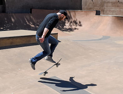 man doing skateboard trick at skateboard park thumbnail