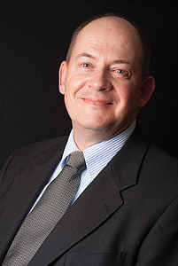 man in black peaked lapel blazer and dress shirt smiling thumbnail