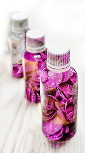 macro photography of three pink and white floral plastic bottles thumbnail