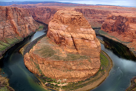 brown cliff near body of water thumbnail