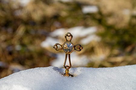gold-colored cross pendant close up photo thumbnail