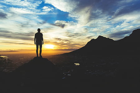 silhouette photo of a man standing of cliff thumbnail
