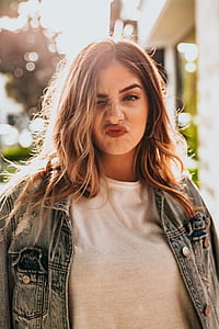 woman in denim jacket with pouting lips thumbnail