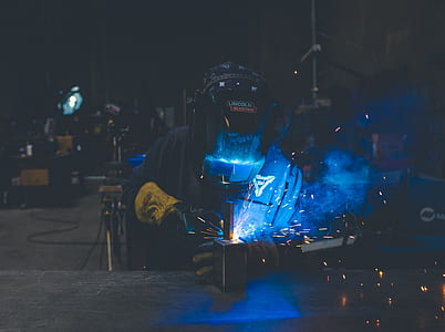 welder wearing gear set while welding metal thumbnail