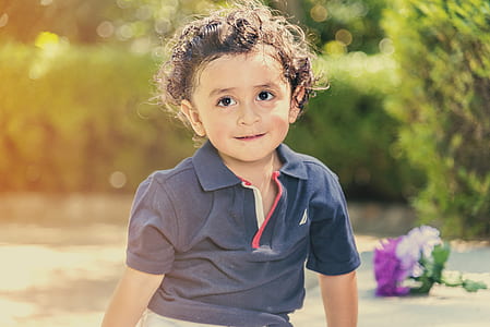 selective photo of toddler's in gray polo shirt thumbnail