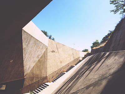 brown concrete tunnel under blue sky thumbnail