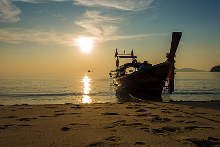 brown boat dock on seashore during daytime thumbnail