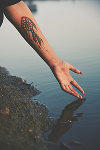 woman with dream catcher arm tattoo thumbnail