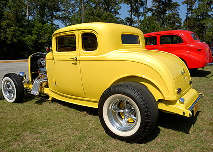 classic yellow and red vehicles parking on grass field at daytime thumbnail