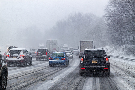 photo of assorted-color vehicles in road during snowtime thumbnail