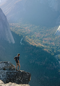 man on mountain cliff during daytime thumbnail