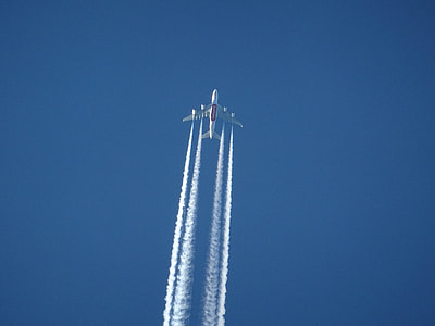 white airplane flying under clear blue sky thumbnail