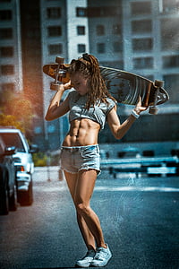 woman wearing gray crop top and blue denim shorts holding a longboard thumbnail