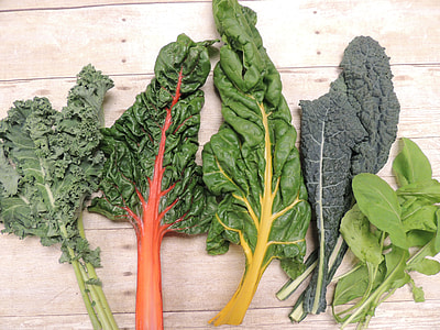 five green leafed vegetables lying on brown wooden surface thumbnail