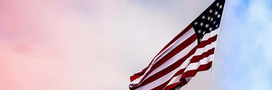 USA flag under white clouds during daytime thumbnail