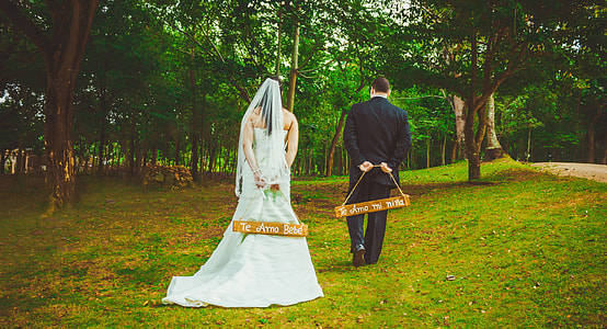 bride and groom holding hanging decor thumbnail