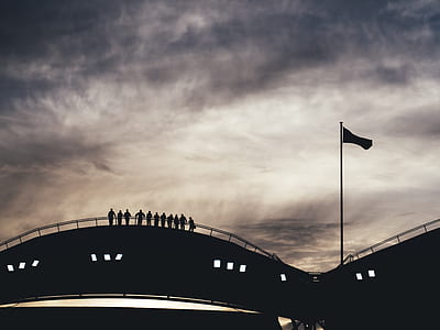 people standing on bridge under cloudy skies thumbnail