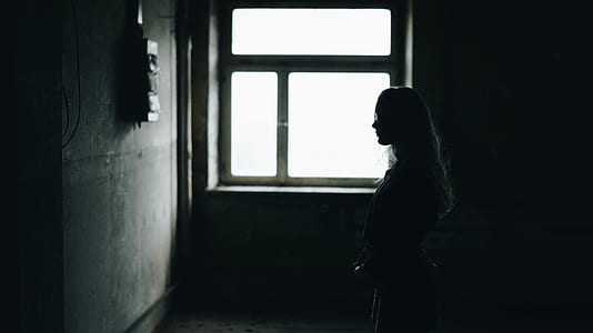 woman standing near window thumbnail