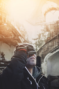 man in black jacket taking picture during daytime thumbnail