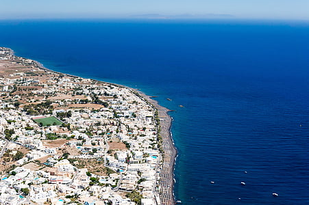 aerial photo of white and brown city beside blue calm body of water at daytime thumbnail