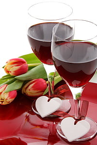 two clear footed glasses with wine thumbnail
