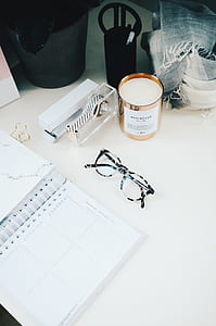 eyeglasses beside white ruled notebook thumbnail