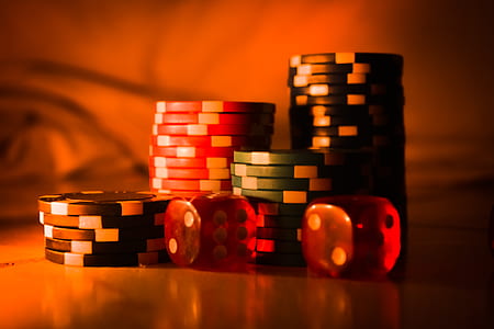 pile of poker chips and two red dices thumbnail