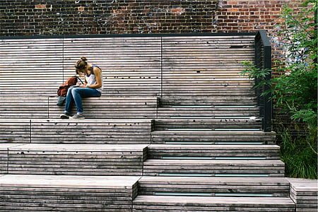 woman sitting on brown concrete stairs thumbnail