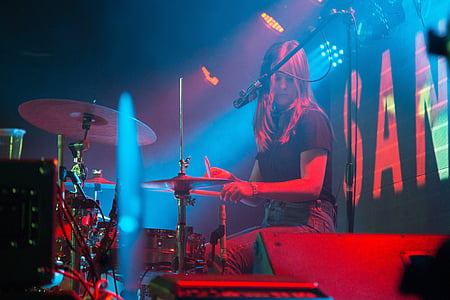 woman plyaing drum beside microphone thumbnail