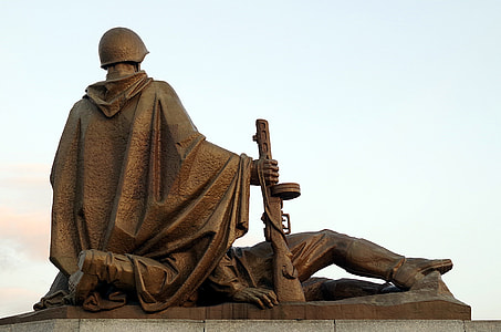 two soldiers kneeling and lying statue during day thumbnail