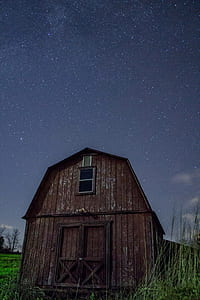 brown barn house under starry night thumbnail